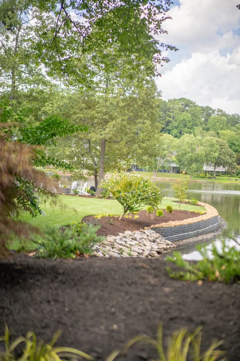 Curved stone retaining wall following the shoreline.