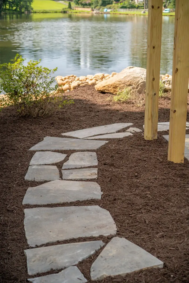 Flagstone stepper path set in fresh mulch.