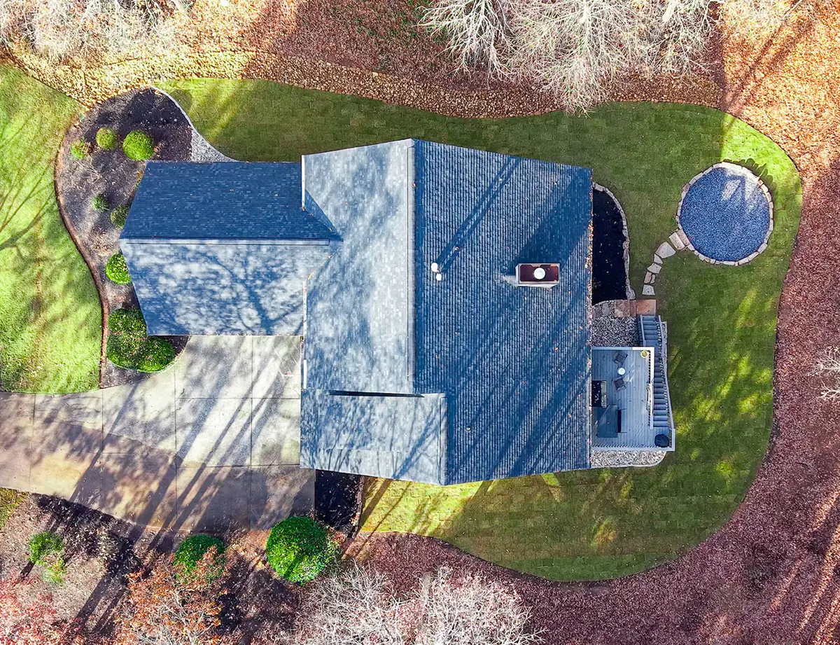 Aerial view of a Cherokee County home with a professionally designed landscape, curved mulched beds and a manicured lawn